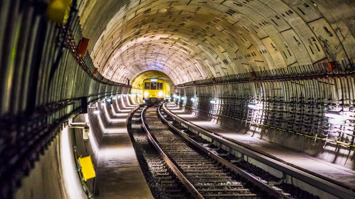Dramatic view of a Berlin subway tunnel with train approaching, showcasing modern infrastructure.